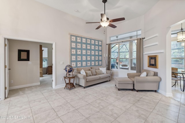 tiled living room with ceiling fan