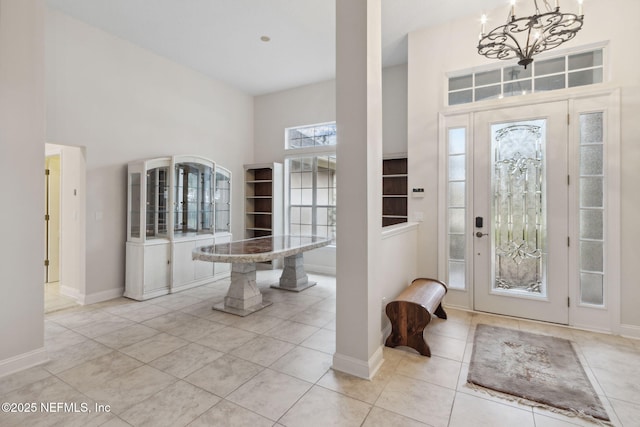 tiled entrance foyer featuring a high ceiling