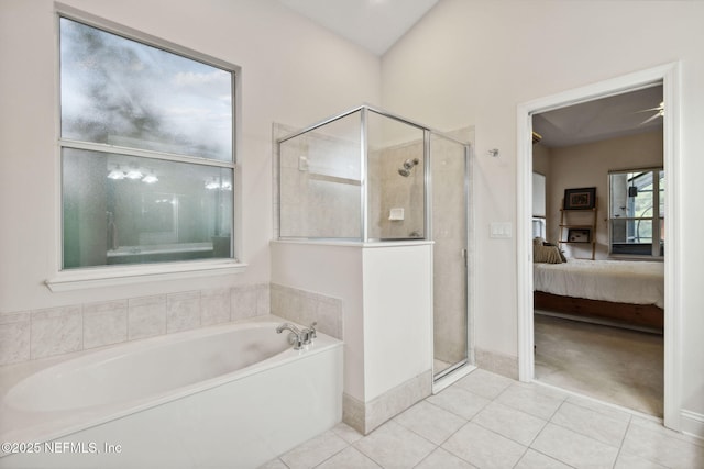 bathroom with tile patterned flooring and separate shower and tub