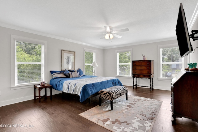 bedroom featuring ceiling fan, dark hardwood / wood-style floors, and ornamental molding