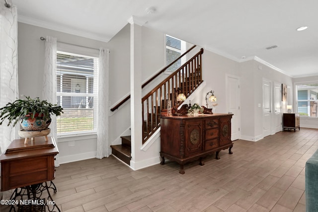 stairway with hardwood / wood-style floors and crown molding