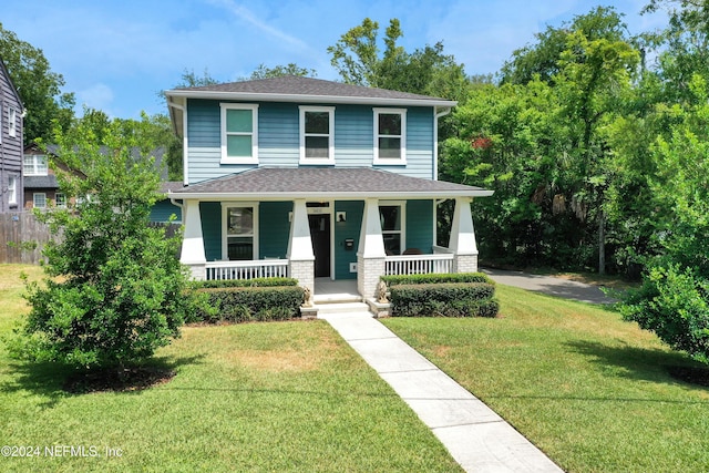 view of front of house featuring a front yard and a porch