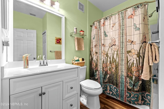 bathroom with hardwood / wood-style flooring, vanity, and toilet