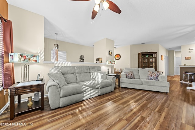 living room featuring hardwood / wood-style floors and ceiling fan