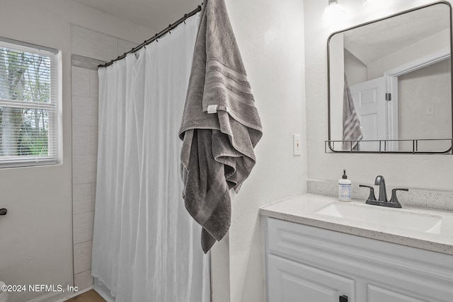 bathroom featuring vanity and walk in shower