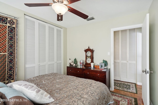 bedroom with parquet floors, a closet, and ceiling fan