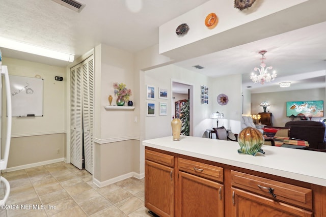 kitchen featuring light tile patterned floors, decorative light fixtures, and a notable chandelier