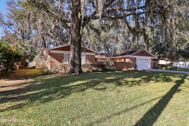 single story home featuring a front yard and a garage