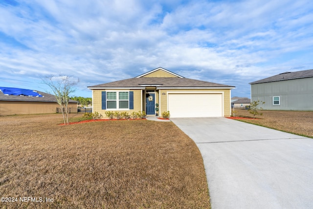 ranch-style house featuring a front lawn and a garage