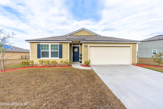 ranch-style house with a garage and a front yard