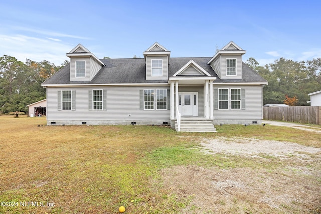 new england style home featuring a front lawn