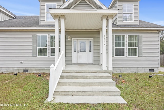 entrance to property with a yard