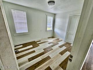 empty room featuring wood-type flooring