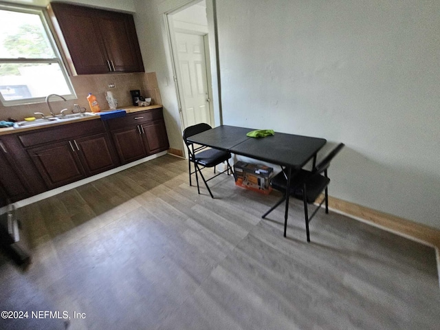 dining space with sink and light hardwood / wood-style flooring