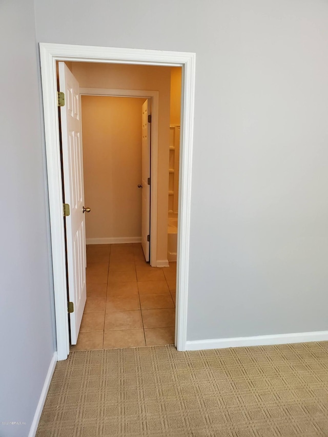 hall with light tile patterned floors