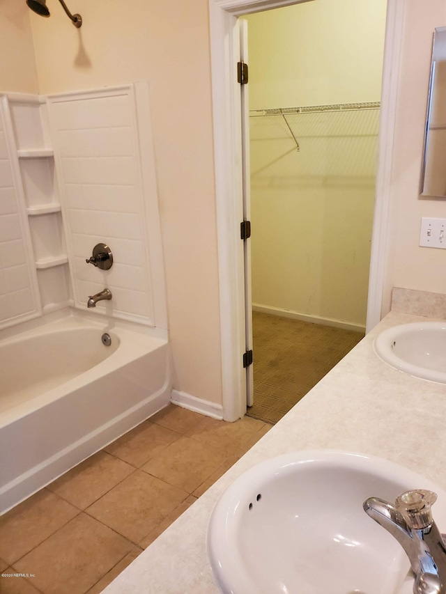 bathroom with tile patterned flooring, vanity, and tub / shower combination