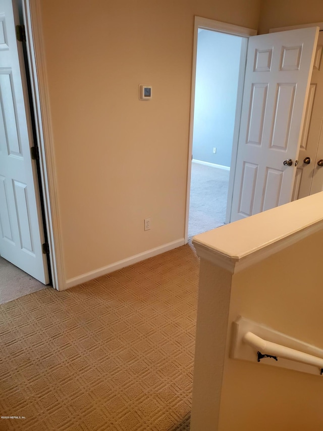 corridor with light colored carpet