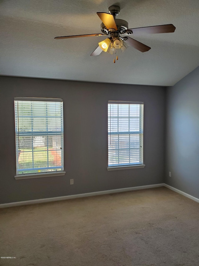 spare room with ceiling fan, carpet floors, and a textured ceiling