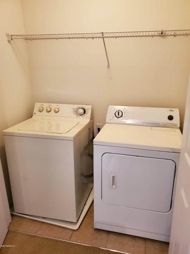 washroom featuring tile patterned floors and washer and clothes dryer