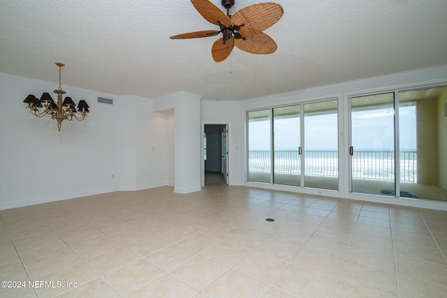 empty room featuring a textured ceiling, crown molding, light tile patterned flooring, and ceiling fan with notable chandelier