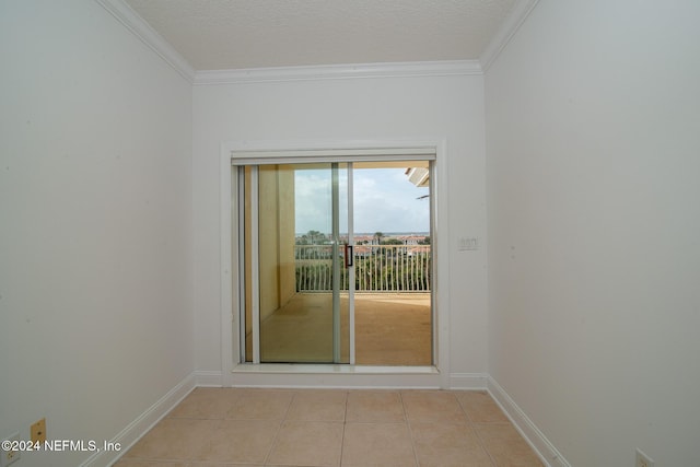 doorway to outside featuring light tile patterned flooring, a textured ceiling, and ornamental molding