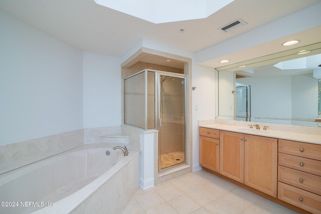 bathroom with tile patterned floors, separate shower and tub, and vanity