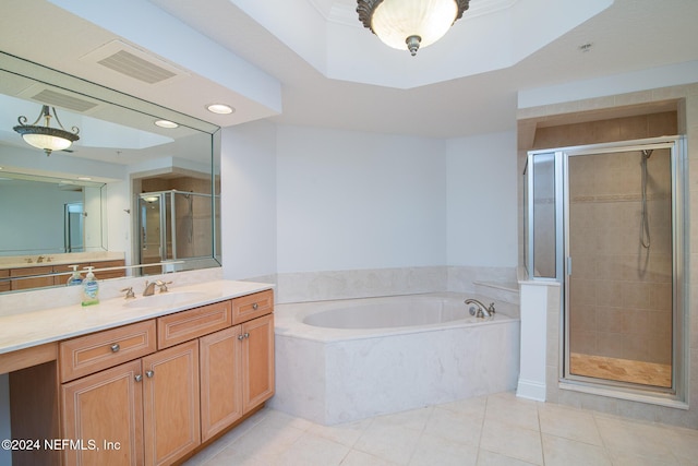 bathroom with tile patterned floors, vanity, and shower with separate bathtub