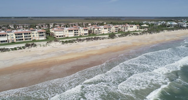 birds eye view of property with a view of the beach and a water view