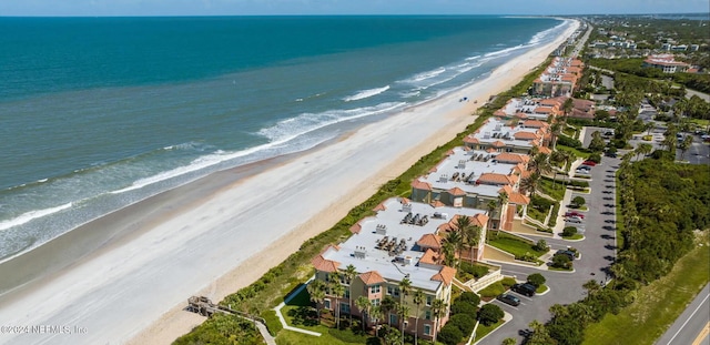 birds eye view of property with a water view and a view of the beach