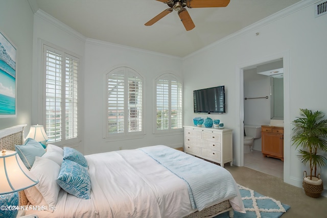 carpeted bedroom featuring connected bathroom, ceiling fan, and ornamental molding