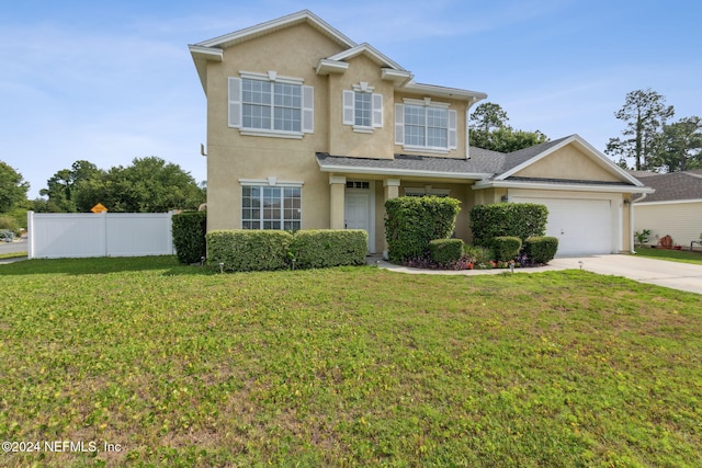 view of front facade with a garage and a front lawn