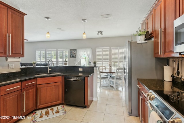 kitchen with dark stone counters, sink, light tile patterned floors, black dishwasher, and hanging light fixtures