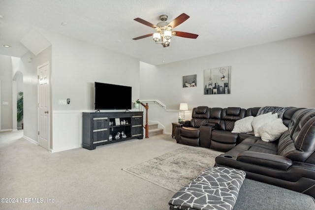 carpeted living room with a textured ceiling and ceiling fan