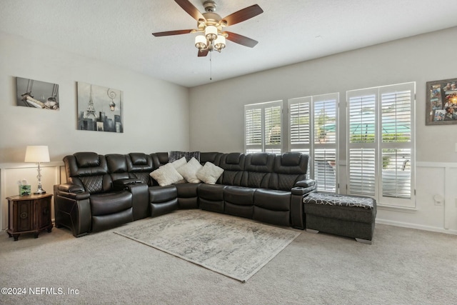 living room featuring ceiling fan, carpet, and a textured ceiling