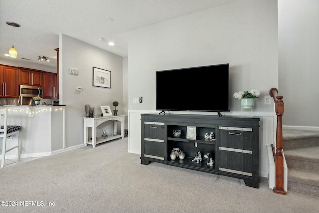 carpeted living room featuring a textured ceiling