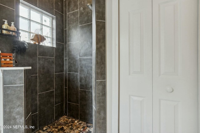 bathroom with tiled shower