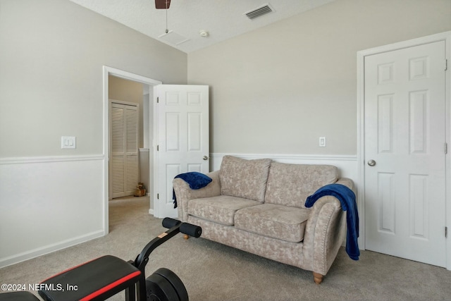 carpeted living room featuring ceiling fan