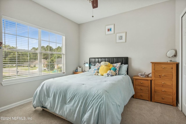 bedroom featuring ceiling fan and light carpet