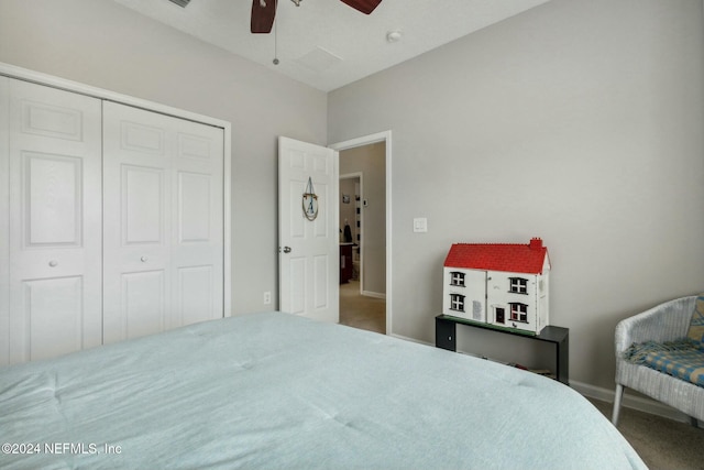 carpeted bedroom featuring a closet and ceiling fan