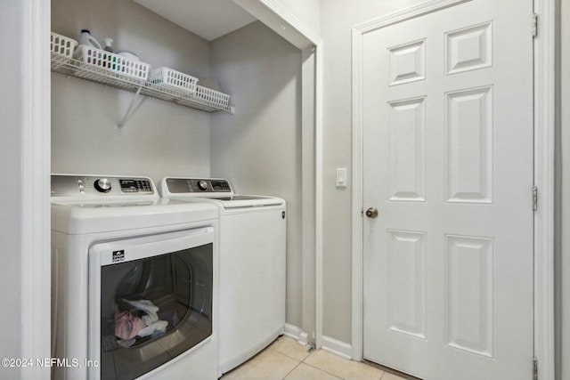 laundry room with light tile patterned floors and washing machine and dryer