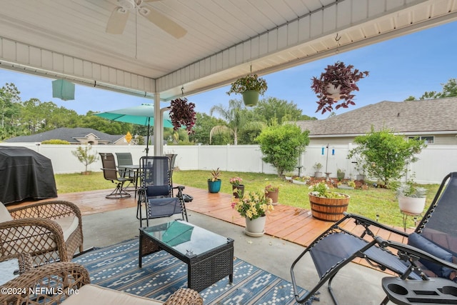 view of patio / terrace featuring a deck, ceiling fan, and a grill