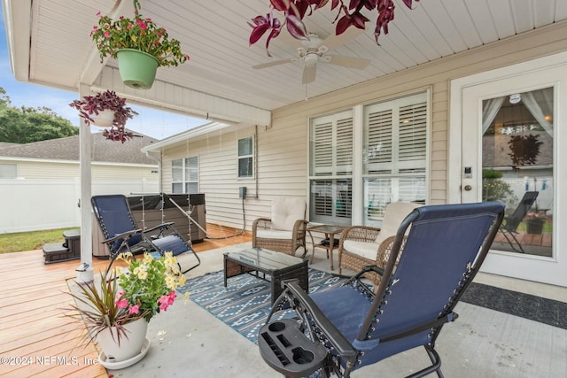 view of patio / terrace with outdoor lounge area, ceiling fan, a wooden deck, and a hot tub