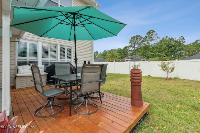 wooden deck with a lawn