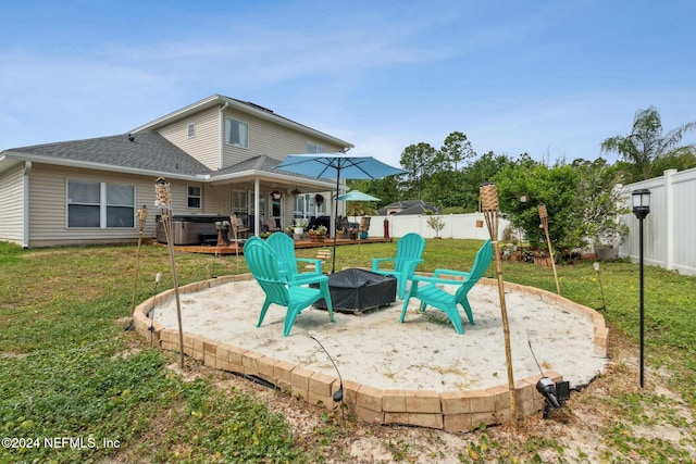 view of patio featuring a hot tub and an outdoor fire pit