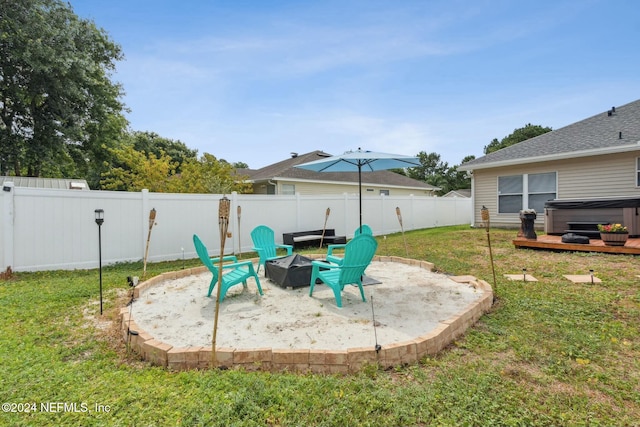 view of patio featuring a hot tub and an outdoor fire pit