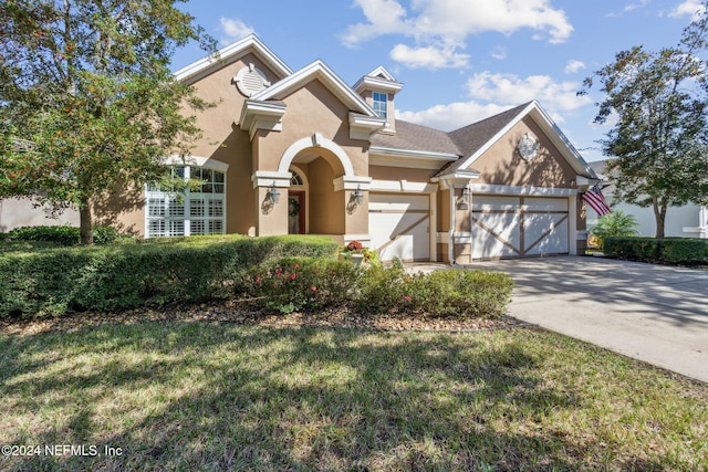 view of front of property featuring a garage and a front yard