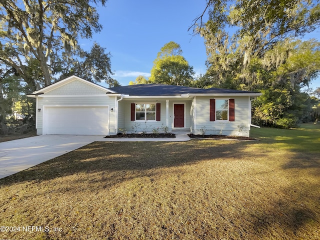 single story home with a front yard and a garage