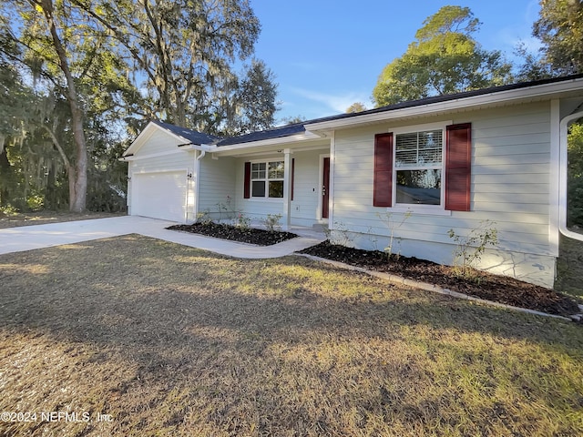 single story home featuring a garage and a front yard