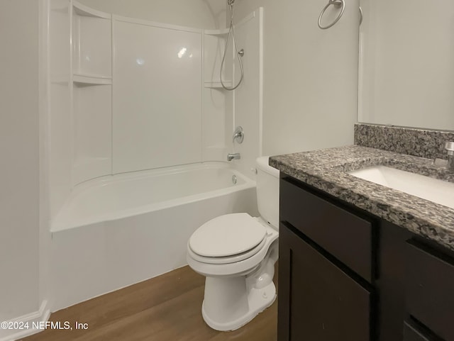 full bathroom with shower / washtub combination, hardwood / wood-style floors, vanity, and toilet