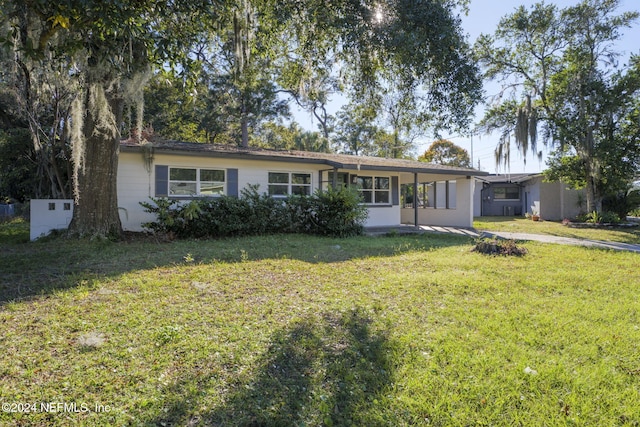 ranch-style house with a front lawn